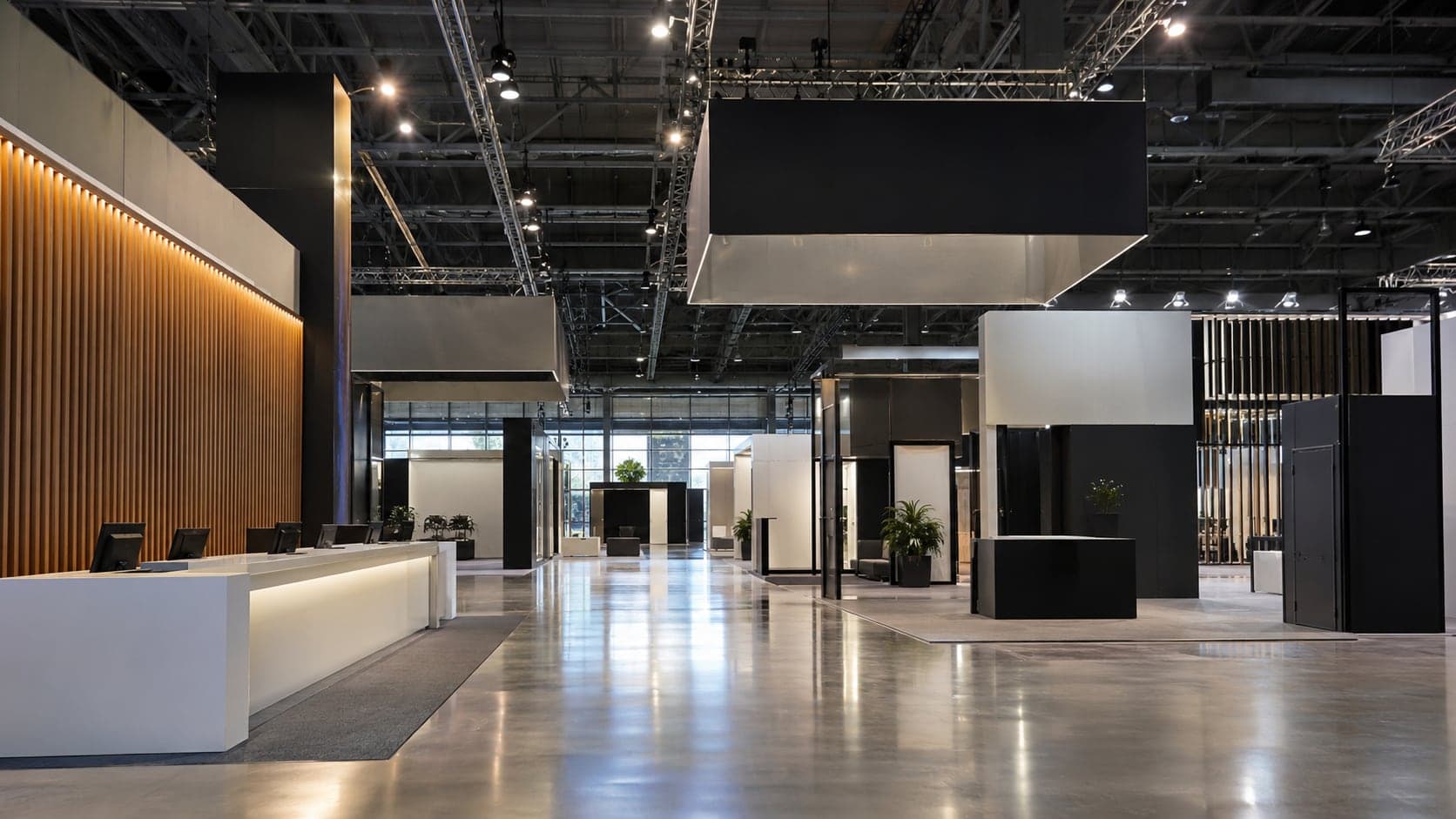 Expo hall with a lit registration counter and custom-built exhibition stands